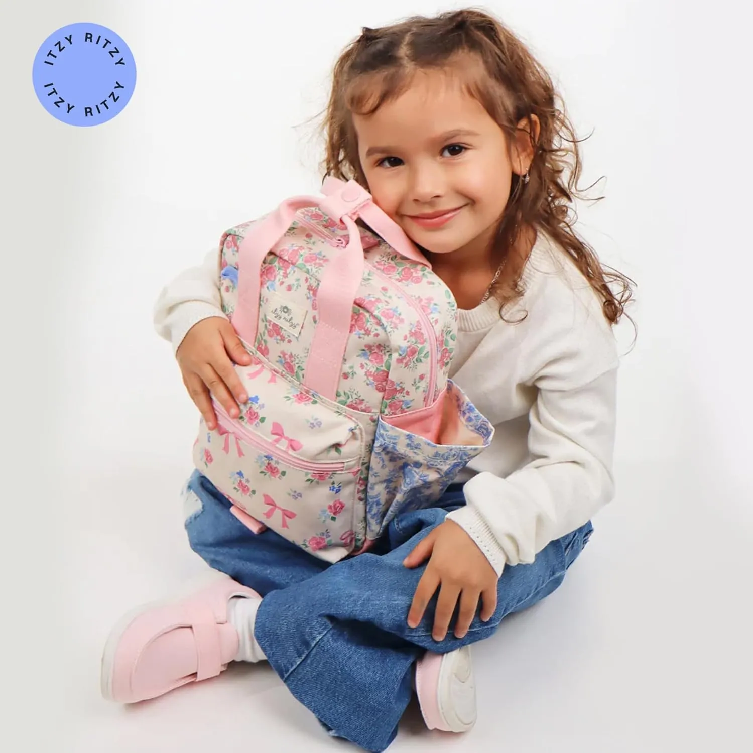 Itzy Ritzy Toddler Backpack - Daycare Bag - Features Adjustable Shoulder Straps, 2 Side Pockets & Spacious Interior with Wipeable Fabric Lining & Name Label, Ribbons & Roses Backpack